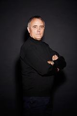 Image showing Serious portrait of mature man in studio with arms crossed, confidence and dark fashion style. Pride, relax and senior person isolated on black background with expert knowledge, mystery and wisdom.