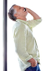 Image showing Laughing, man and joke by phone call with smartphone, discussion and positive with comic with listener. Mature person, cellphone and talking with happy on technology and wellness by white background