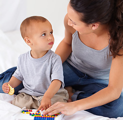 Image showing Abacus, bonding and baby with mother playing, learning and teaching for child development on bed. Math, toy and closeup of mom helping kid, infant or toddler with counting in bedroom at home.