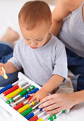 Image showing Abacus, toy and baby with mother playing, learning and teaching for child development on bed. Math, bonding and closeup of mom helping kid, infant or toddler with counting in bedroom at home.