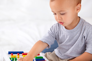 Image showing Abacus, math and boy baby learning, playing and teaching for child development on bed. Preschool, youth and closeup of kid, infant or toddler with counting for toy in bedroom or nursery at home.