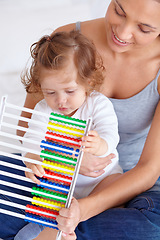 Image showing Abacus, education and baby with mother playing, learning and teaching for child development on bed. Bonding, toy and closeup of mom helping kid, infant or toddler with counting in bedroom at home.