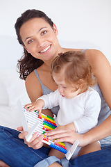 Image showing Smile, portrait and baby with mother on abacus playing, learning and teaching for child development on bed. Bonding, toy and mom with kid, infant or toddler with counting in bedroom at home.