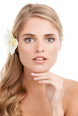 Image showing Woman, portrait and confidence in studio with flower, serious and pride for cosmetic treatment or glow. Model, person or face with hand for haircare organic skincare, or self care on white background