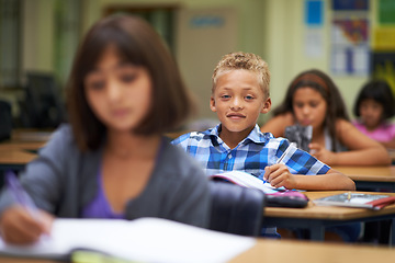 Image showing Students, classroom and writing for learning, elementary school and diverse children workbook. Portrait, study and childhood development for education, knowledge and academic information for people