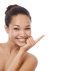 Image showing Woman, portrait and pointing at mockup for beauty, space and brand ambassador for skincare. Person, promotion and face in studio or marketing, direction and advertising offer on white background