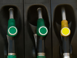 Image showing Green and yellow gas  pump rack