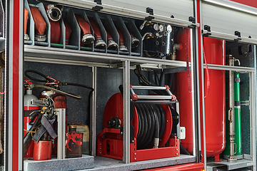 Image showing Close-up of essential firefighting equipment on a modern firetruck, showcasing tools and gear ready for emergency response to hazardous fire situations