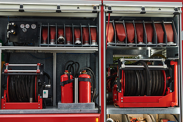 Image showing Close-up of essential firefighting equipment on a modern firetruck, showcasing tools and gear ready for emergency response to hazardous fire situations