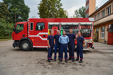 Image showing A skilled and dedicated professional firefighting team proudly poses in front of their state of the art firetruck, showcasing their modern equipment and commitment to ensuring public safety.