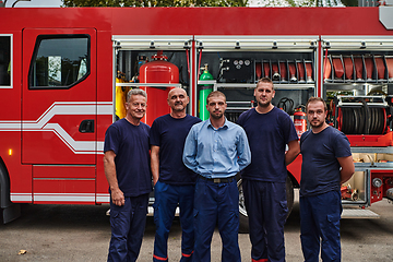 Image showing A skilled and dedicated professional firefighting team proudly poses in front of their state of the art firetruck, showcasing their modern equipment and commitment to ensuring public safety.