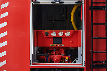 Image showing Close-up of essential firefighting equipment on a modern firetruck, showcasing tools and gear ready for emergency response to hazardous fire situations