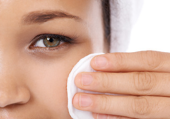 Image showing Woman face, cotton pad and closeup for skin care, beauty and cosmetics product with dermatology results in studio. Portrait of person or model eye with hygiene wipe for makeup on a white background