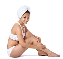 Image showing Woman, legs and skin care in studio portrait for hair removal results and beauty on floor on a white background. Young person or happy model in underwear with body cosmetics, skincare and dermatology