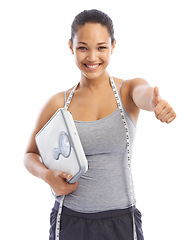 Image showing Happy woman, portrait and thumbs up with scale, tape measure or weight loss against a white studio background. Female person or model smile with like emoji, yes sign or OK for good diet or success