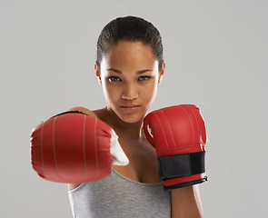 Image showing Woman, portrait and boxing fighter ready for competition against a gray studio background. Face of female person or professional boxer with gloves for fitness, self defense or MMA challenge in sports