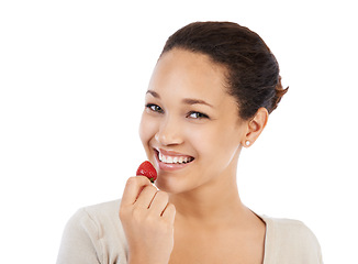 Image showing Portrait, woman and eating strawberry in studio for healthy detox, vegan diet and nutrition on white background. Happy model, red berries and sustainable benefits of food, vitamin c and sweet fruits