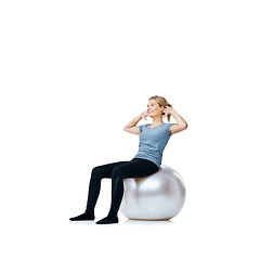 Image showing Happy woman, ball or sit up on a white background space for workout, wellness or mobility exercise. Female athlete training, smile or fitness for mockup, core strength or body challenge in studio