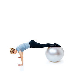 Image showing Woman, fitness and push ups with exercise ball for balance training, workout or health and wellness on a white studio background. Female person or athlete on round object for pilates on mockup space