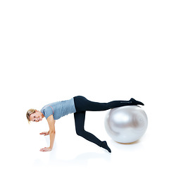 Image showing Happy woman, fitness and exercise ball for balance, workout or health and wellness on a white studio background. Female person or athlete smile on round object for training or pilates on mockup space