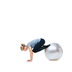 Image showing Woman, legs and exercise ball for balance, workout or health and wellness on a white studio background. Active female person or athlete on round object in fitness, training or pilates on mockup space