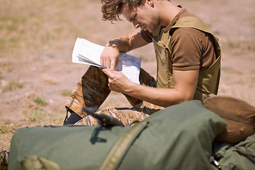 Image showing Man with map on battlefield, planning battle location or tactical operation goals for mission in war. Soldier is outdoor at military base camp, check strategy paperwork with army target and attack
