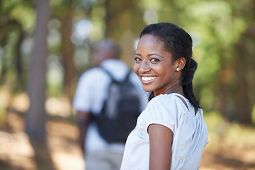 Image showing Portrait, smile and black woman hiking in the forest together with her husband for travel, freedom or adventure. Face, nature or environment with a young hiker in the woods or wilderness for vacation