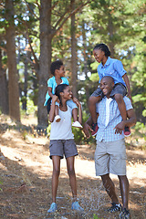 Image showing Happy, travel or black family hiking in forest to relax or bond on holiday vacation together in nature. Children siblings, mother or African father in woods trekking on outdoor adventure with smile