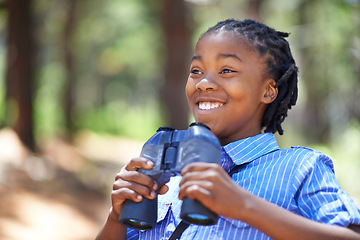 Image showing Binocular, search or happy boy child in forest hiking, sightseeing or discovery. Lens, equipment or excited African kid in nature for adventure, learning or seeing, explore or watching while camping