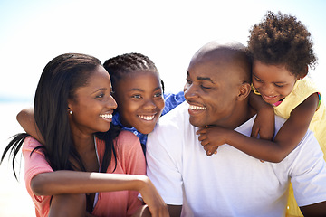 Image showing Happy, love and black family at the beach together for tropical vacation, adventure or holiday. Smile, travel and young African parents with girl children by the ocean for bonding weekend trip.