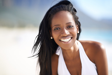 Image showing Portrait of black woman on beach, relax and smile on holiday with travel, sunshine and tropical island. Sea, happy and african girl on ocean vacation in summer with adventure, peace and calm water.