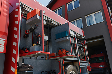 Image showing Close-up of essential firefighting equipment on a modern firetruck, showcasing tools and gear ready for emergency response to hazardous fire situations