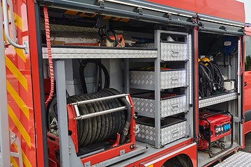 Image showing Close-up of essential firefighting equipment on a modern firetruck, showcasing tools and gear ready for emergency response to hazardous fire situations