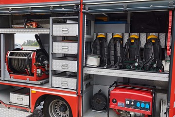 Image showing Close-up of essential firefighting equipment on a modern firetruck, showcasing tools and gear ready for emergency response to hazardous fire situations