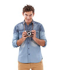 Image showing Portrait, smile and camera with a photographer man in studio isolated on a white background for a hobby. Creative, technology and photography with a happy young person holding picture equipment