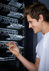 Image showing Server room, man and check cables with smile, thinking and connectivity with hardware in night. Cybersecurity system, it network and technician for glitch, data center and problem solving for error