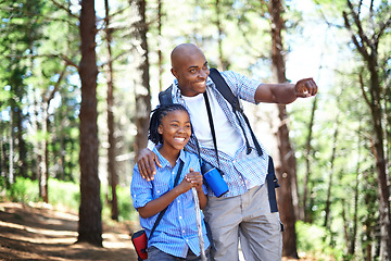 Image showing Happy black family, forest and hiking for bonding, fresh air or exploring together in nature. Dad pointing and showing child or kid trees on adventure for holiday, weekend or outdoor trip in woods