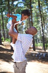 Image showing Playing, father and child in forest with smile, happiness and adventure in nature for summer holiday fun. Bonding, black man and playful son in woods for vacation, trekking in trees and energy games.