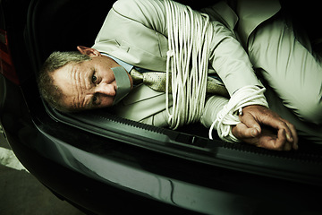Image showing Car boot, hostage or portrait of business man with tape, rope and kidnap danger in parking lot. Fear, stress and face of male victim in a vehicle trunk with anxiety, horror or crime, scared or ransom