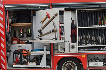 Image showing Close-up of essential firefighting equipment on a modern firetruck, showcasing tools and gear ready for emergency response to hazardous fire situations