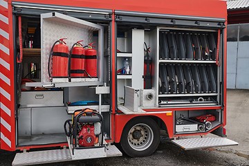 Image showing Close-up of essential firefighting equipment on a modern firetruck, showcasing tools and gear ready for emergency response to hazardous fire situations