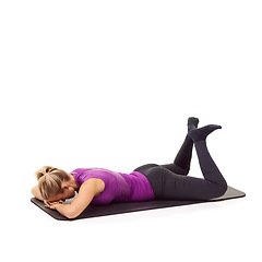 Image showing Yoga, woman and stretching legs on the floor in white background, mock up and studio. Pilates, exercise and person workout on ground with feet raised in air in pose for fitness, health or wellness