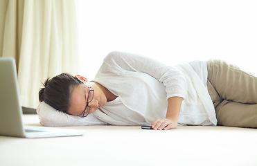 Image showing Remote work, burnout and tired woman sleeping on a floor with low energy, exhausted or nap after laptop project. Freelance, fatigue or female person in living room for, dreaming or break in house