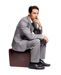 Image showing Stress, thinking and business man with briefcase in studio for travel, fail or mistake on white background. Doubt, anxiety and person sitting on a bag with headache, disaster or compliance problem