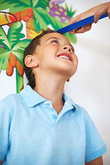 Image showing Smile, kid and hands measure height, check future increase in growth of boy and track length in home together. Happy, young child and development on ruler, tall or family with scale for size in house