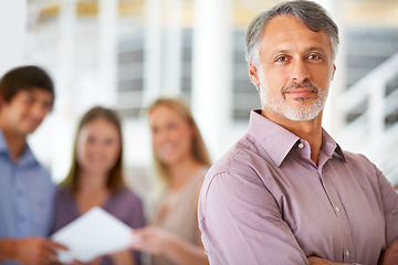 Image showing Office, confidence and portrait of business man with team for leadership, crossed arms and pride. Corporate, company and happy worker with staff for meeting, planning and collaboration in workplace