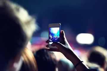 Image showing Woman, hand and smartphone for picture at concert with post, social media or recording of show. Closeup, female person and mobile app for sharing on internet for music, event or festival with crowd