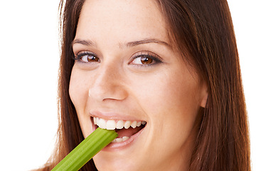 Image showing Happy, portrait and woman with celery in a studio for health, wellness and diet snack for lunch. Smile, weight loss and closeup face of young female model eating a vegetable by white background.