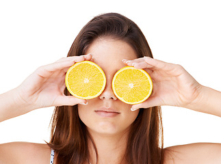 Image showing Woman cover face with orange fruits in studio for detox, vegan diet and natural skincare for nutrition on white background. Serious girl, citrus and healthy food for sustainable benefits of vitamin c