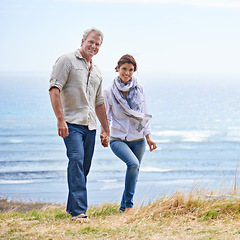 Image showing Happy, mature couple and portrait of holding hands at the sea, ocean or walk on the beach in retirement. Summer, vacation or holiday with old man and woman together with love and support in marriage